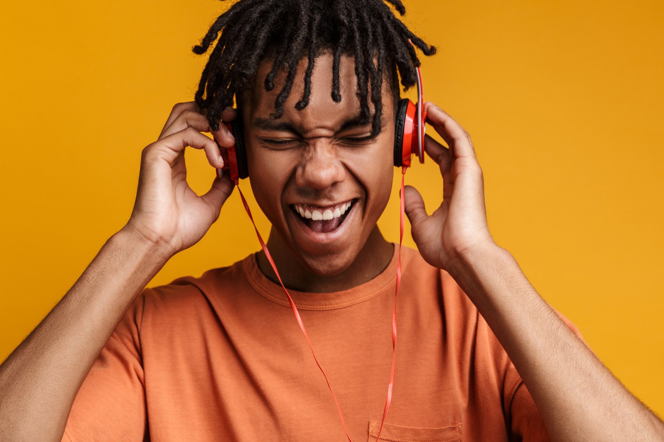 Portrait of a Happy African American Teen Listening to Music