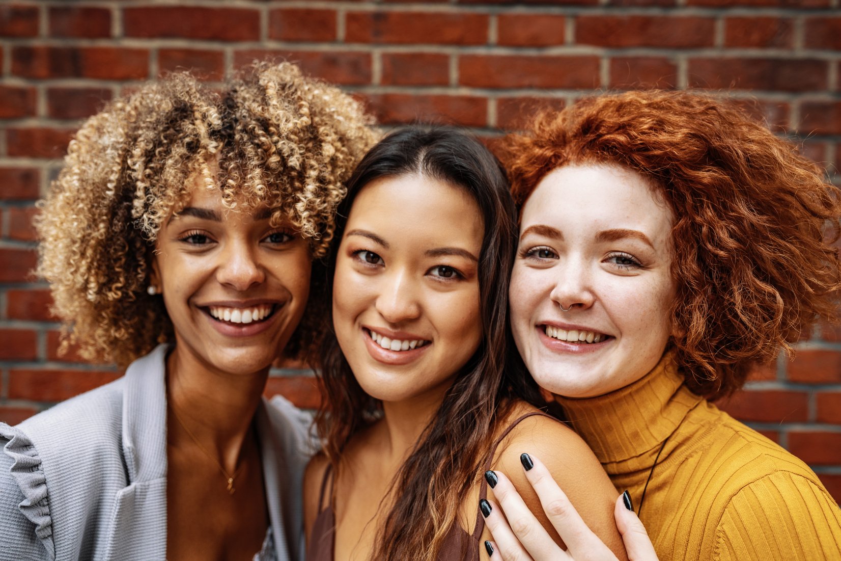 Diverse youth - girl power. Three multi-ethnic women looking at camera